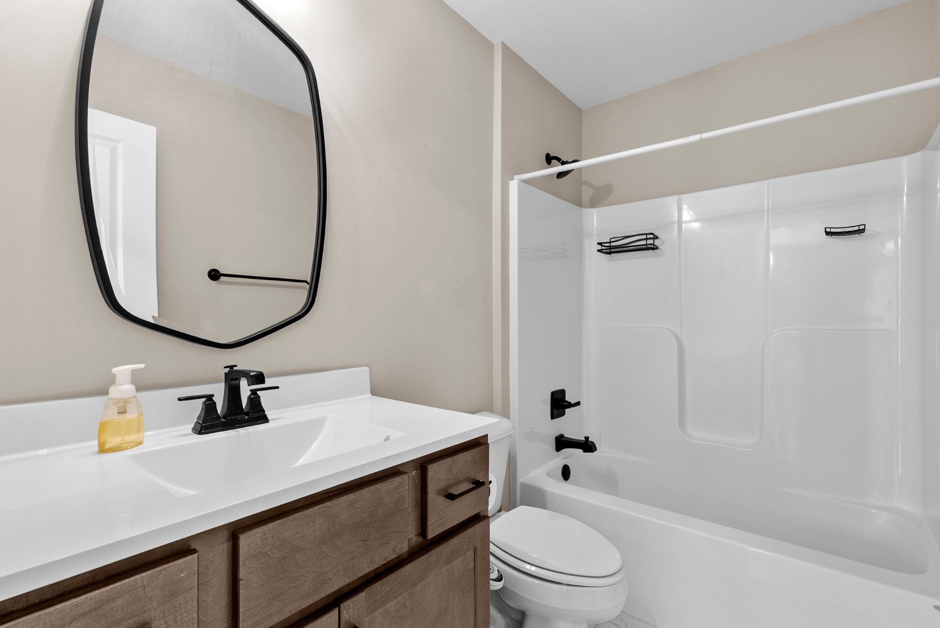 Primary bath with dual vanities and tiled walk-in shower